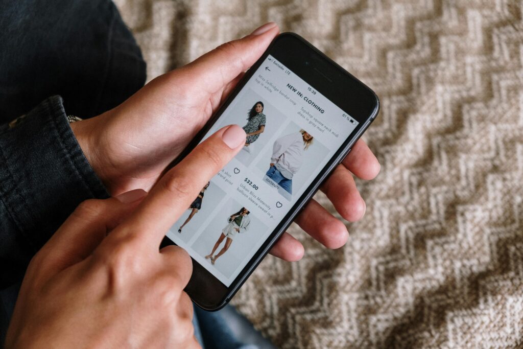 an image of a person browsing clothes online using mobile